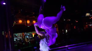 Dancer Ginger spinning upside down on the Stripper Pole on the main stage.